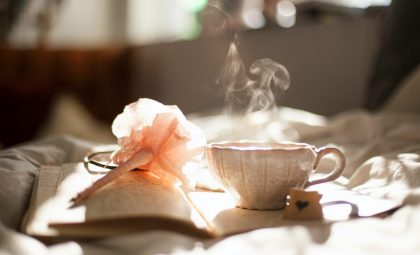 A steamy cup of tea on a book.