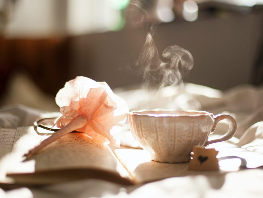 A steamy cup of tea on a book.