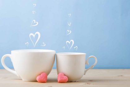 Two teacups with steam hearts