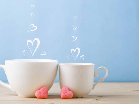 Two teacups with steam hearts
