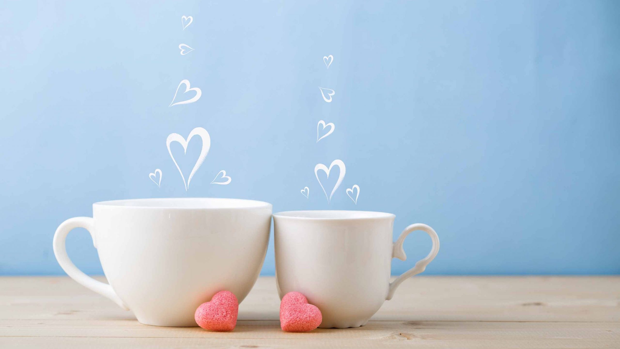 Two teacups with steam hearts
