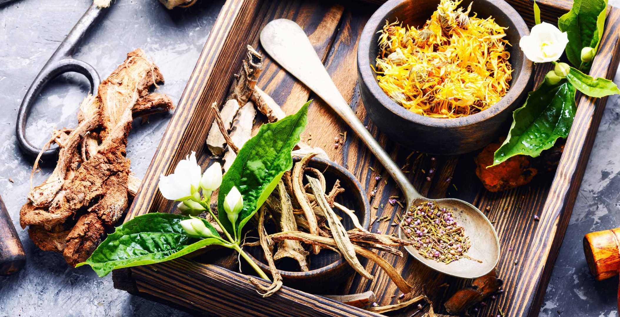 a wooden tray with herbs